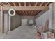 Unfinished basement area with exposed ceiling, concrete floor, and a life preserver at 1751 S Centennial Ave, New Palestine, IN 46163