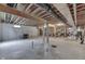 Large unfinished basement area with exposed ceiling, concrete floor, and partial framing at 1751 S Centennial Ave, New Palestine, IN 46163