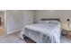 This bedroom features neutral walls and a large bed with a patterned comforter for a relaxing retreat at 1751 S Centennial Ave, New Palestine, IN 46163