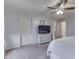 Spacious bedroom with carpeted floor, neutral tones, a ceiling fan, and ample closet space at 1751 S Centennial Ave, New Palestine, IN 46163