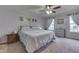 Cozy bedroom with neutral tones, carpeted floor, a ceiling fan, and two windows at 1751 S Centennial Ave, New Palestine, IN 46163