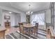A well-lit dining room featuring a classic chandelier, round table, and soft, sheer curtains at 1751 S Centennial Ave, New Palestine, IN 46163