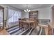 Elegant dining room featuring a wooden table, chairs, china cabinet, and natural light at 1751 S Centennial Ave, New Palestine, IN 46163