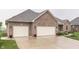 Lovely brick home exterior showcasing a driveway, manicured lawn, and a convenient two-car garage at 1751 S Centennial Ave, New Palestine, IN 46163