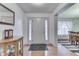 Inviting home foyer with a hardwood floor, complemented by a wooden cabinet and dining room views at 1751 S Centennial Ave, New Palestine, IN 46163