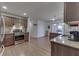 Open kitchen featuring wood cabinets, granite countertops, stainless steel appliances, and hardwood floors at 1751 S Centennial Ave, New Palestine, IN 46163