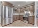 Modern kitchen featuring stainless steel appliances, ample cabinet space, and tile backsplash at 1751 S Centennial Ave, New Palestine, IN 46163