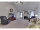 Cozy living room with plush seating, a fireplace, vaulted ceilings, and ample natural light at 1751 S Centennial Ave, New Palestine, IN 46163
