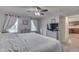 Bright main bedroom with neutral tones, carpeted floor, two windows and ensuite bathroom at 1751 S Centennial Ave, New Palestine, IN 46163