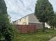 View of a grassy backyard with a stained wood fence, complemented by mature trees at 1774 Blue Grass Pkwy, Greenwood, IN 46143