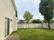 Expansive backyard featuring a well-maintained lawn and a classic white wooden fence for privacy at 1774 Blue Grass Pkwy, Greenwood, IN 46143