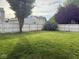 Large, well-maintained backyard with a lush lawn and a white privacy fence, ideal for outdoor activities at 1774 Blue Grass Pkwy, Greenwood, IN 46143