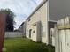 View of the backyard of the home featuring a lush lawn and privacy fence, with the house in the background at 1774 Blue Grass Pkwy, Greenwood, IN 46143