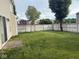 The home has a large backyard featuring a green lawn, privacy fence, and some mature trees at 1774 Blue Grass Pkwy, Greenwood, IN 46143