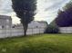 Grassy backyard enclosed by a white fence, providing a private outdoor space at 1774 Blue Grass Pkwy, Greenwood, IN 46143