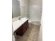 Well-lit bathroom featuring a combined bathtub and shower, vanity sink, and neutral-toned flooring at 1774 Blue Grass Pkwy, Greenwood, IN 46143