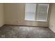 A bedroom with a window bringing in natural light and carpeting on the floor at 1774 Blue Grass Pkwy, Greenwood, IN 46143