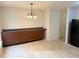 Charming dining area with ample cabinet space, illuminated by a modern chandelier at 1774 Blue Grass Pkwy, Greenwood, IN 46143