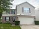 Inviting two-story home with a well-manicured lawn and attached two-car garage at 1774 Blue Grass Pkwy, Greenwood, IN 46143
