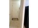 A hallway with tile flooring, a white door, and a black refrigerator to the side at 1774 Blue Grass Pkwy, Greenwood, IN 46143