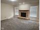 Bright living room featuring a stone fireplace with a wooden mantle, creating a focal point in the space at 1774 Blue Grass Pkwy, Greenwood, IN 46143