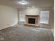 Comfortable living room featuring a stone fireplace and natural light from large windows at 1774 Blue Grass Pkwy, Greenwood, IN 46143