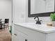 Bathroom vanity with modern fixtures, a sleek sink, and a black framed mirror at 1837 S East St, Indianapolis, IN 46225