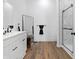 Bathroom features modern vanity, tile shower, wood-look flooring, and neutral wall paint at 1837 S East St, Indianapolis, IN 46225