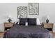 Bedroom featuring cozy bedding, side tables with lamps, and botanical wall art at 1837 S East St, Indianapolis, IN 46225