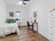 Bright bedroom with a bed, desk, ceiling fan, and natural light at 1837 S East St, Indianapolis, IN 46225