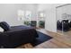 Bedroom with bed, chair, mirrored closets, and plenty of natural light at 1837 S East St, Indianapolis, IN 46225