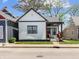 Charming home with a white exterior, black trim, and a cozy front porch area at 1837 S East St, Indianapolis, IN 46225