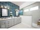 Luxurious bathroom with dual sinks, gray cabinets, modern lighting, and a glass-enclosed shower with blue tiling at 19848 Chatsworth Blvd, Westfield, IN 46074