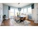 Elegant dining room with a long table, stylish chairs, and ample natural light from large windows at 19848 Chatsworth Blvd, Westfield, IN 46074