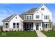 Charming two-story home with a mix of white and green siding, complemented by a well-manicured lawn and stone accents at 19848 Chatsworth Blvd, Westfield, IN 46074