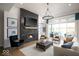 Spacious living room featuring a fireplace with a black tile surround, hardwood floors, and large windows with a view at 19848 Chatsworth Blvd, Westfield, IN 46074