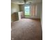 Neutral bedroom with carpet, a window offering natural light, and a built-in closet for storage at 2026 S Q St, Elwood, IN 46036