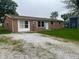 Charming single-story home with brick and tan siding, a white door, and a gravel drive in the front at 2026 S Q St, Elwood, IN 46036