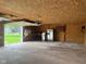 Spacious garage interior with concrete floors, a workbench, and ample storage for tools and equipment at 2026 S Q St, Elwood, IN 46036