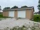 Two-car detached garage with white doors and beige siding, providing ample parking and storage space at 2026 S Q St, Elwood, IN 46036