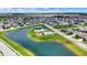 Community aerial view highlighting a playground, swimming pool and lake in a well-maintained neighborhood at 2201 Schoolmarm Dr, Greenfield, IN 46140