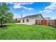 This backyard features a lawn and patio with fenced yard at 2201 Schoolmarm Dr, Greenfield, IN 46140