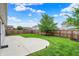 Expansive backyard with a concrete patio, lush green lawn, and privacy fence, ideal for outdoor enjoyment at 2201 Schoolmarm Dr, Greenfield, IN 46140