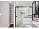 Bright bathroom featuring black fixtures, tiled shower and shelving unit at 2201 Schoolmarm Dr, Greenfield, IN 46140