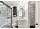 Stylishly updated bathroom with tiled shower, modern vanity, and closet at 2201 Schoolmarm Dr, Greenfield, IN 46140