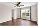 Empty bedroom with a window, dark wood floors, ceiling fan and neutral walls at 2201 Schoolmarm Dr, Greenfield, IN 46140