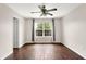 Bright, empty bedroom featuring a ceiling fan, hardwood floors, and natural light at 2201 Schoolmarm Dr, Greenfield, IN 46140