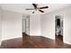 Spacious bedroom featuring hardwood floors, ceiling fan, and ensuite bathroom access at 2201 Schoolmarm Dr, Greenfield, IN 46140