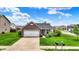 Attractive brick and siding home with a two-car garage and a neatly landscaped front yard at 2201 Schoolmarm Dr, Greenfield, IN 46140
