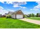 Single-Gathering home on a large lot featuring a manicured lawn and an attached two-car garage with brick facade at 2201 Schoolmarm Dr, Greenfield, IN 46140